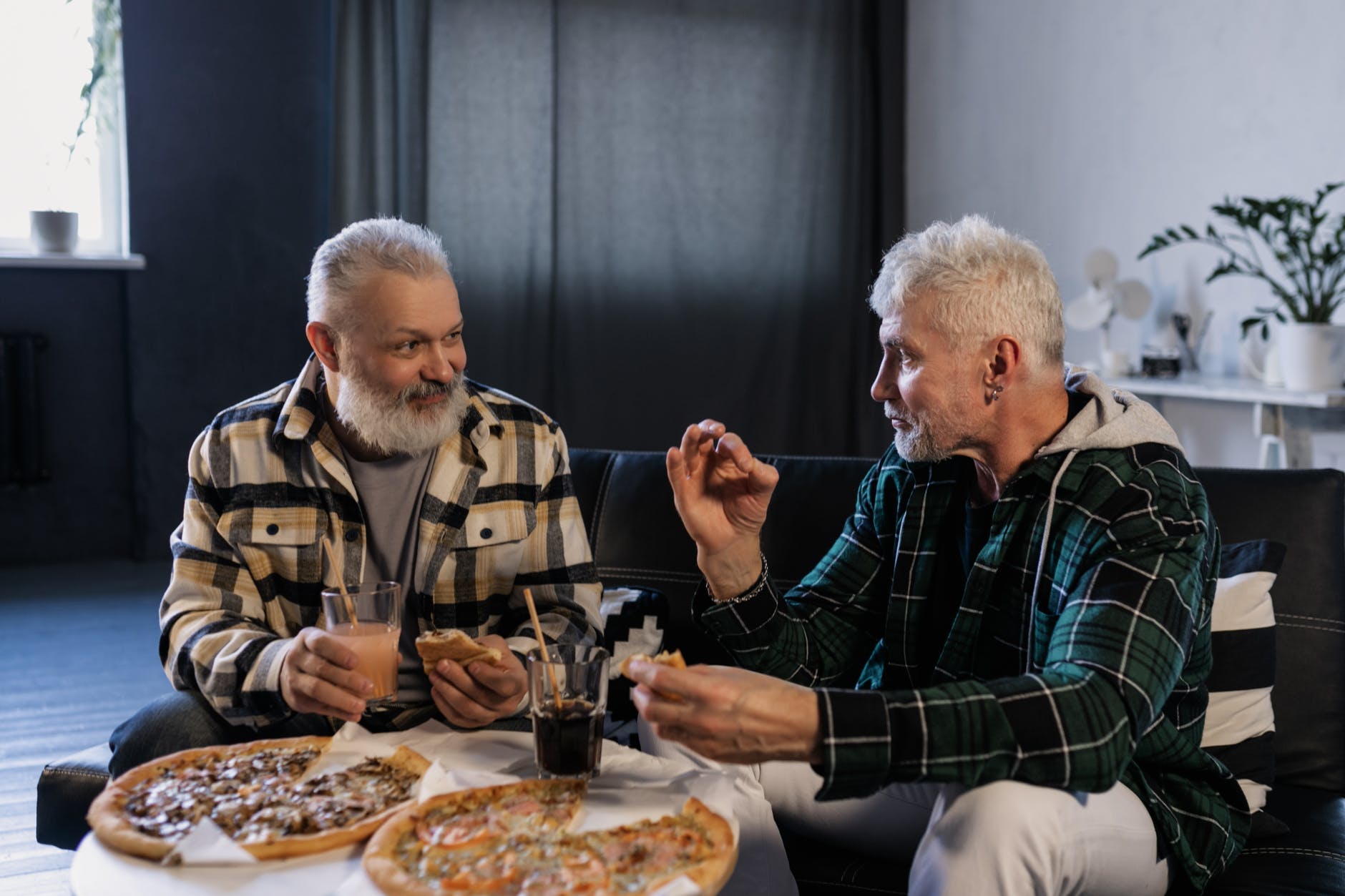 elderly men eating while talking to each other